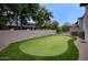 Backyard putting green with manicured lawn, surrounded by mature trees at 18916 N 98Th St # 3709, Scottsdale, AZ 85255