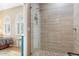 En suite bathroom with large glass shower enclosure and tile surround at 21026 N Circle Cliffs Dr, Surprise, AZ 85387