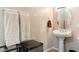 Half bath featuring a pedestal sink, toilet, and towel rack at 21026 N Circle Cliffs Dr, Surprise, AZ 85387