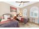 Bedroom showcasing twin beds, ceiling fan, wood floors, and bright windows at 21026 N Circle Cliffs Dr, Surprise, AZ 85387