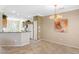 Open dining and kitchen area with chandelier, breakfast bar, and white appliances at 21026 N Circle Cliffs Dr, Surprise, AZ 85387