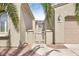 Light tan home featuring private courtyard with metal gate and desert landscaping at 21026 N Circle Cliffs Dr, Surprise, AZ 85387