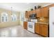 Bright kitchen with oak cabinets, modern appliances, and tile floors near a breakfast nook at 21026 N Circle Cliffs Dr, Surprise, AZ 85387