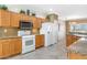 Well-lit kitchen featuring wooden cabinets, granite countertops, and modern white appliances at 21026 N Circle Cliffs Dr, Surprise, AZ 85387