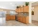 Spacious kitchen boasts stainless steel dishwasher, granite counters, and tile flooring at 21026 N Circle Cliffs Dr, Surprise, AZ 85387