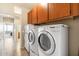 Efficient laundry area with washer, dryer, and overhead cabinetry for storage at 21026 N Circle Cliffs Dr, Surprise, AZ 85387