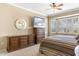 Comfortable main bedroom featuring dresser, television, ceiling fan, and bay window at 21026 N Circle Cliffs Dr, Surprise, AZ 85387