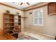 Inviting office space with built-in shelving, neutral walls, and comfortable desk chair at 21026 N Circle Cliffs Dr, Surprise, AZ 85387