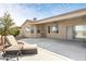 Covered patio with ceiling fan, chaise lounge chairs, and desert landscaping at 21026 N Circle Cliffs Dr, Surprise, AZ 85387