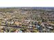 An aerial view captures a sprawling residential neighborhood with diverse homes and a city skyline in the backdrop at 2140 W Mitchell Dr, Phoenix, AZ 85015