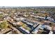 Aerial view of a residential neighborhood with desert landscaping and a skyline in the distance at 2140 W Mitchell Dr, Phoenix, AZ 85015