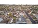 Aerial view of a residential area with single-Gathering homes, desert landscaping, and a cityscape in the distance at 2140 W Mitchell Dr, Phoenix, AZ 85015