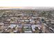 Panoramic aerial view featuring diverse single-Gathering homes, lush greenery, and a stunning city skyline at 2140 W Mitchell Dr, Phoenix, AZ 85015