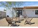 Backyard patio featuring seating, desert landscaping, metal privacy fencing and a pergola at 2140 W Mitchell Dr, Phoenix, AZ 85015