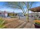 Landscaped backyard with a cozy seating area, hot tub, and lush desert plants at 2140 W Mitchell Dr, Phoenix, AZ 85015