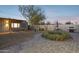 Expansive backyard with custom lighting, outdoor dining area, and hammock offering space for relaxation and entertainment at 2140 W Mitchell Dr, Phoenix, AZ 85015