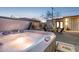 Backyard with hot tub, metal privacy fence, seating area and desert landscaping at 2140 W Mitchell Dr, Phoenix, AZ 85015
