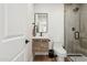 Modern bathroom features a walk-in shower, sleek fixtures, stylish wood vanity and contemporary finishes at 2140 W Mitchell Dr, Phoenix, AZ 85015