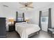 Cozy bedroom with a ceiling fan, neutral color palette, and natural light from the windows at 2140 W Mitchell Dr, Phoenix, AZ 85015