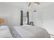 Bright bedroom with a ceiling fan, white walls, and a large window with grey curtains, providing a serene and restful space at 2140 W Mitchell Dr, Phoenix, AZ 85015