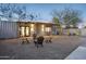 Modern home with gravel landscaping, outdoor seating, and covered patio creating a unique and inviting outdoor living space at 2140 W Mitchell Dr, Phoenix, AZ 85015