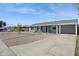 Single story home with a covered porch, desert landscaping, and a large driveway at 2140 W Mitchell Dr, Phoenix, AZ 85015