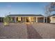 Charming single story home with desert landscaping, covered porch, grey exterior and a garage at 2140 W Mitchell Dr, Phoenix, AZ 85015
