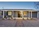 Home exterior featuring a covered front porch with desert landscaping and brick walkway at 2140 W Mitchell Dr, Phoenix, AZ 85015