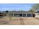 Single story home with desert landscaping, brick walkway, covered porch with seating at 2140 W Mitchell Dr, Phoenix, AZ 85015