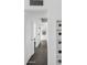 Inviting hallway with sleek tile flooring, built-in shelving, and a view to an office space, blending style with functionality at 2140 W Mitchell Dr, Phoenix, AZ 85015