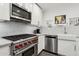 Modern kitchen featuring stainless steel appliances and white cabinetry at 2140 W Mitchell Dr, Phoenix, AZ 85015