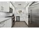Modern kitchen with white cabinets, stainless steel appliances, and granite countertops at 2140 W Mitchell Dr, Phoenix, AZ 85015