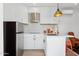 Contemporary kitchen featuring white cabinets, stainless steel appliances, and a stylish faucet at 2140 W Mitchell Dr, Phoenix, AZ 85015