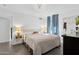 Bright bedroom featuring a comfortable bed, soft lighting, and stylish decor at 2140 W Mitchell Dr, Phoenix, AZ 85015