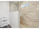 Luxurious walk-in shower with marble tile, glass enclosure, and modern fixtures at 2140 W Mitchell Dr, Phoenix, AZ 85015