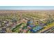 Aerial view of a community with a golf course, tennis courts, swimming pool and well maintained desert landscaping at 23108 N Pedregosa Dr, Sun City West, AZ 85375