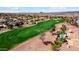 This aerial showcases homes on a golf course with lush green fairways and surrounding desert landscapes; golfers can be seen at 23108 N Pedregosa Dr, Sun City West, AZ 85375