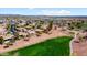 Aerial view of a well maintained residential community with desert landscaping and a nearby green golf course at 23108 N Pedregosa Dr, Sun City West, AZ 85375