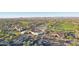 Overhead shot of a community with a clubhouse, golf course, parking lot, and mountain views in the distance at 23108 N Pedregosa Dr, Sun City West, AZ 85375