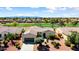 Aerial view of a home and community showcasing desert landscaping, a golf course, and mountain views in the distance at 23108 N Pedregosa Dr, Sun City West, AZ 85375