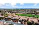 Aerial view of a desert community with beautiful homes, a golf course, and mountain views in the distance at 23108 N Pedregosa Dr, Sun City West, AZ 85375