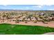 This aerial view captures a residential community with a nearby golf course; golf carts can be seen on the course at 23108 N Pedregosa Dr, Sun City West, AZ 85375