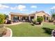 Well-maintained backyard with lush green lawn, patio furniture, and landscaping at 23108 N Pedregosa Dr, Sun City West, AZ 85375