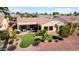 Well maintained backyard featuring artificial turf, desert landscaping and covered patio with outdoor seating at 23108 N Pedregosa Dr, Sun City West, AZ 85375