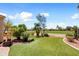 Lush backyard with artificial turf and desert landscaping, overlooking a scenic golf course at 23108 N Pedregosa Dr, Sun City West, AZ 85375