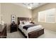 Cozy bedroom with a dark wood bed, white comforter and carpet flooring at 23108 N Pedregosa Dr, Sun City West, AZ 85375