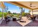 Relaxing covered patio with ample seating, bar area, and views of the lush golf course at 23108 N Pedregosa Dr, Sun City West, AZ 85375