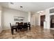 Formal dining room with modern chandelier, tile floors, and dark wood furniture at 23108 N Pedregosa Dr, Sun City West, AZ 85375