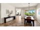 Elegant dining room with views of the backyard and access to the open-concept living area at 23108 N Pedregosa Dr, Sun City West, AZ 85375