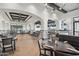 An open-concept restaurant with tables, chairs, and large windows, arched entryways, and stylish interior design at 23108 N Pedregosa Dr, Sun City West, AZ 85375
